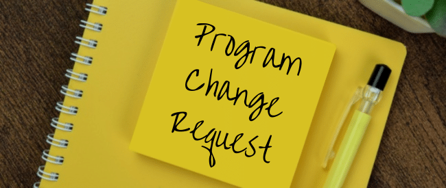 Expresso Program Change Request on yellow sticky note