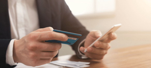 Man paying bills with electronic bill presentment and payment app on mobile phone.