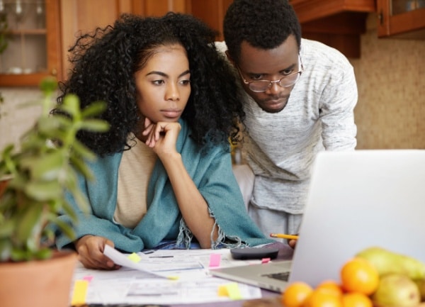 Young African American couple paying medical bills on laptop